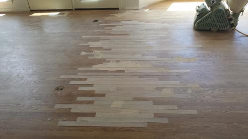 Hardwood floor addition lacing new flooring into an existing room