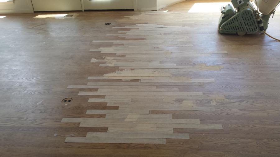 Hardwood floor addition lacing new flooring into an existing room